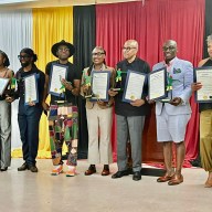 GCA Award recipients holding Stick Figure statues, Proclamations from Congresswoman Yvette D. Clarke, and Citations from Senator Roxanne J. Persaud. From left: Errol Hazelwood, Johanna Rae George, Calvin Booker, Andy Ninvalle, Roxanne Lashley, Dr. Vibert Cambridge, Anthony Alleyne, Lorraine Croft-Farnell, and Latoya Asim.