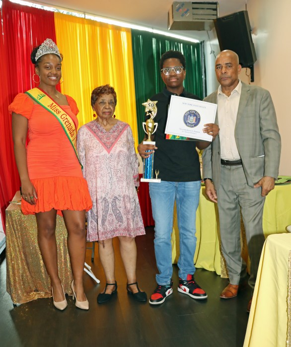 Josiah Henry displays his trophy and certificate, flanked by Cecily Mason, Mickalia Forrester-Ewen, left, and Consul General Raphael M. Brizan.