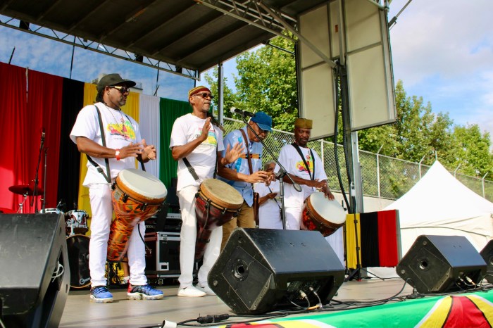 From left, Shawn Thompson, Winston "Jaggae" Hoppy, Dr. Vibert Cambridge, and Akoya Rudder perform a libation and drumming salute to late GCA Executive Director Claire Ann Goring during the Annual Folk Festival fun day at Old Boys and Girls High School in Crown Heights, Brooklyn.