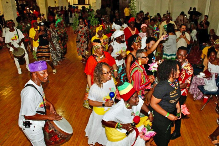 GCA Executive Member Verna Walcott-White (foreground) led the wedding party at the high-spirited Kwe Kwe demonstration at St. Stephens' Church Hall in Brooklyn. This was a signature event of the Annual Guyana Folk Festival. She was accompanied by dancer Michele Singh, and African drummer Akoyaw Rudder.