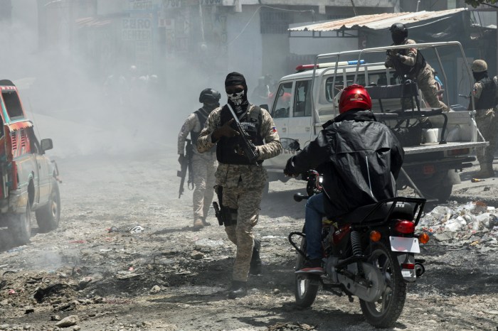 Police officers patrol after dissipating demonstrators protesting for the help of the state and security forces, after gangs set several houses on fire, in Port-au-Prince, Haiti Aug. 19, 2024.