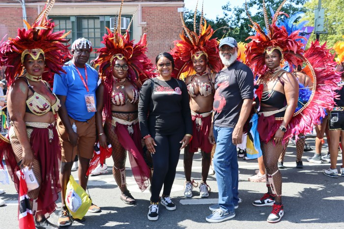 Edwin Worrell, second from left, Derek Noel, second from right, with masqueraders in Deck Productions, Branches and Associates, and Mango Tree Productions's "A Touch of Class.”