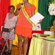 Mickalia Forrester-Ewen, Miss Grenada USA addressed ceremony at Nutmeg House, with Cecily Mason, president of the Grenadian-American Ex-Teacherss Association in background.