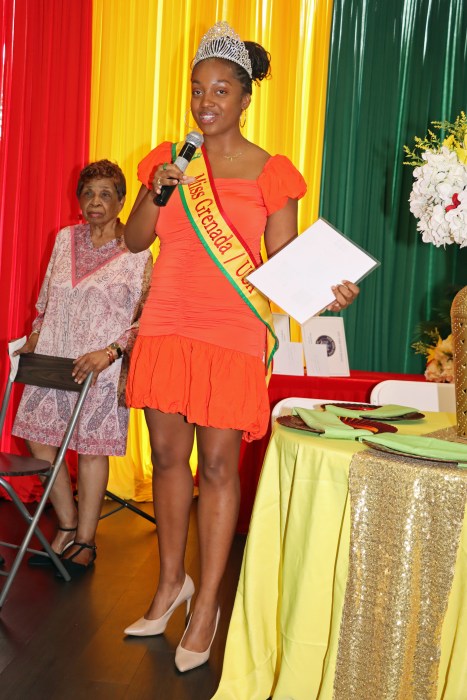 Mickalia Forrester-Ewen, Miss Grenada USA addressed ceremony at Nutmeg House, with Cecily Mason, president of the Grenadian-American Ex-Teacherss Association in background.