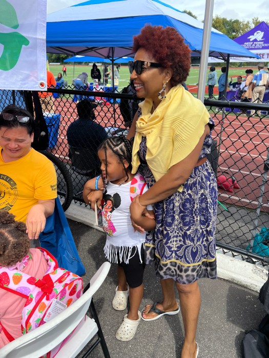 Council Member Mercedes Narcisse shares a light moment with parents and children.