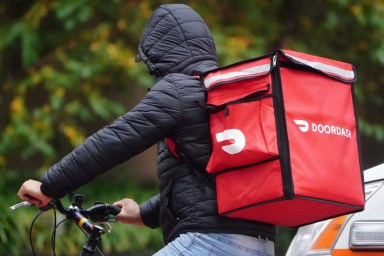 A delivery person for Doordash rides his bike in the rain in the Manhattan borough of New York City, New York, U.S., November 13, 2020.