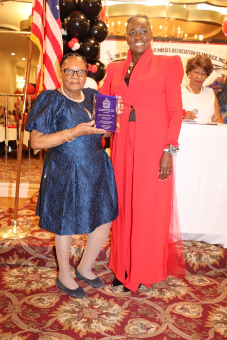 Naomi Henry receives an award from President-Elect Dr. Cynthia Sterling-Fox, right.