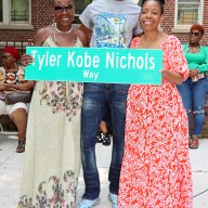 Council Member Rita Joseph, right, presents replica of Tyle Kobe Nichols Way to Sherma Chambers, flanked by Tyron Stearns, community coordinator for the 67th Precinct Clergy Council, popularly known as The GodSquad, who presided over the ceremony with Joseph.