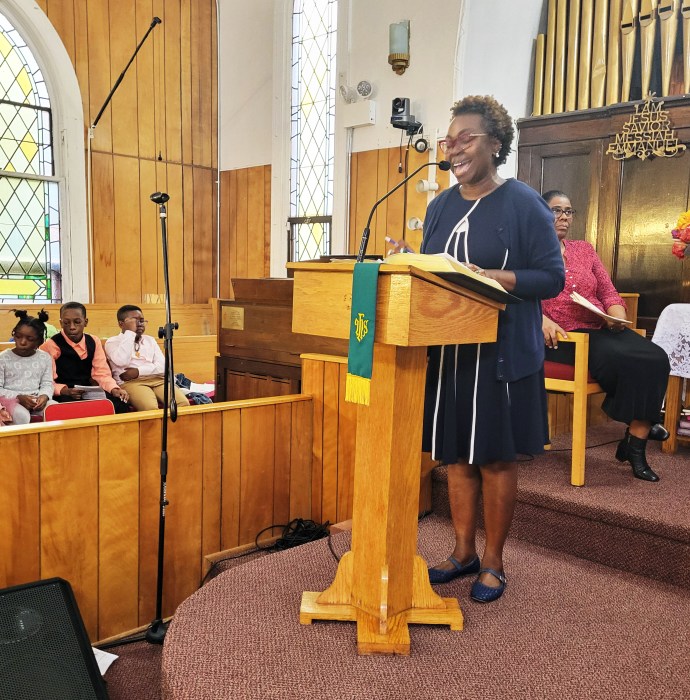 Lawyer Abayomi Whint addresses the congregation at Fenimore Street United Methodist Church.