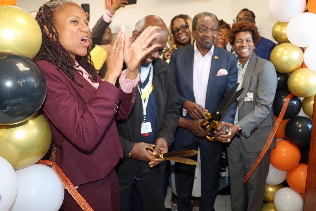 Assembly Member Monique Chandler-Waterman, left, applauds as former Assembly Member Nick Perry, second from right, cuts the ribbon, flanked by Dr. Rev. Waterman, vice chair of the OBH Board of Trustees, second from left, and Dr. Sandra Scott, interim CEO of OBH, right.