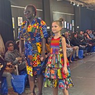 Designer Constance Bernard and a young model showcase a standout piece on the runway.