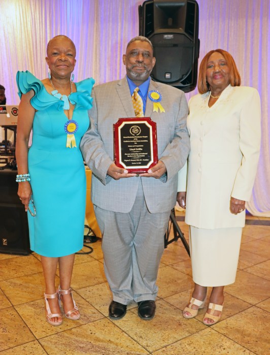 Lloyd Griffin receives surprise CANA/BMW Chapter Award from Dr. Virginia Bernard, RN, right, and Griffin's wife, Pamela Griffin, RN.