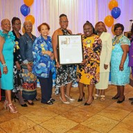 CANA/BMW Chapter members pose with a proclamation held by Dawn Africa, DNP, RN, sixth from left, and Dahniel Samuel.