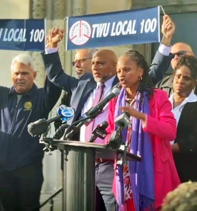 Assembly Member Chandler-Waterman stands beside TWU local 100 members President Richard Davis and Sharase DuBouse to advocate for stronger transit safety measures.