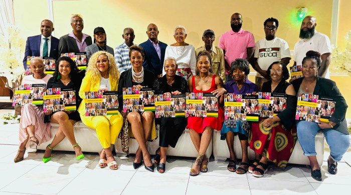 Dr. Royale-Davis (center, front row) poses with several individuals featured in her book during the launch event.