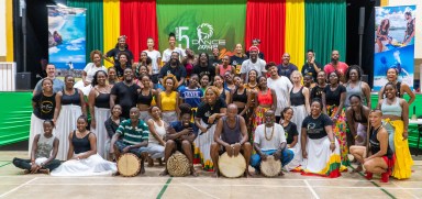 Dance Grenada Founder and Executive Artistic Director Dr. Shola K. Roberts (seventh from left), along with participants of the 5th annual Dance Grenada Festival and the Ousoo Drummers, pose for a group photo following a vibrant and immersive Shango dance class led by renowned Grenadian dancer Keith Willams.