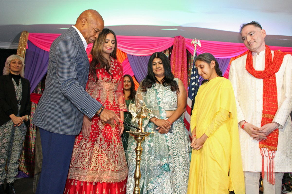 Mayor Eric Adams left, lights the Diya, as Assembly MemberJenifer Rajkumar, (partly hidden) CEO, Gracie Mansion Conservancy Rhonda Binda, South Asian Liaison, Community Affairs Unit, Sookranie Dhanpat, a religious leader, and Deputy Commissioner, Mayor’s Office of International Affairs, Dilip Chauhan, look on, at the annual Diwali celebration at Gracie Mansion, on Oct. 24.