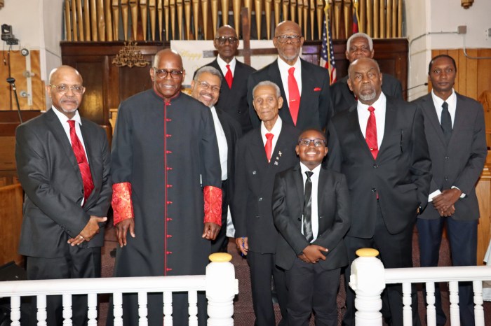 Pastor the Rev. Roger Jackson, second from left, front row, with 9-year-old Nicolas Charles, who offered the opening prayer, and the Men's Committee at Fenimore Street United Methodist Church.