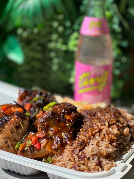 Jerk chicken dipped in barbecue sauce, served with rice and peas.