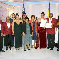 Dr. Veronica Francois-Kydd, fourth from right, receives award and proclamations, flanked by VINCI members and Council Member Mercedes Narcisse, fifth from right Narcisse, VINCI President Wayne Ragguette, third from right (holding citation), and representative of U.S. Rep. Yvette D. Clarke.