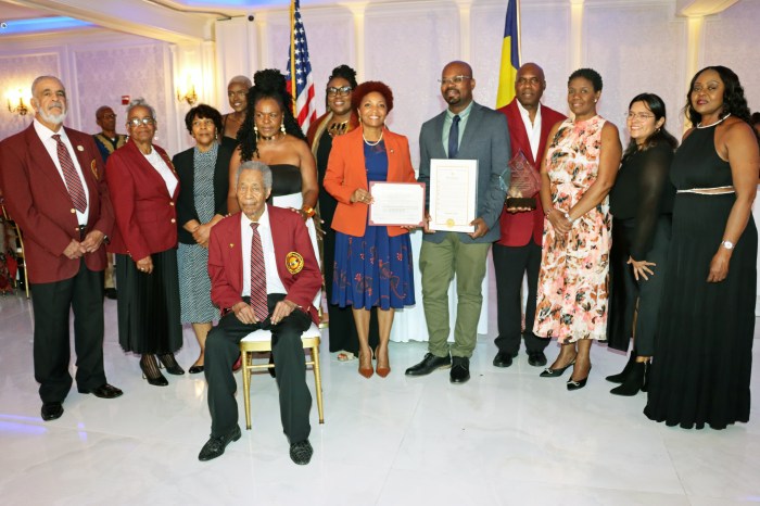 Kamal Rose, fifth from right, holds proclamation, flanked by Council Member Mercedes Narcisse, sixth from right, holding citation, Amb. Lou-Ann Gilchrist, third from right, U.S. Rep. Yvette D. Clarke's representative, second from right, and members of VINCI.