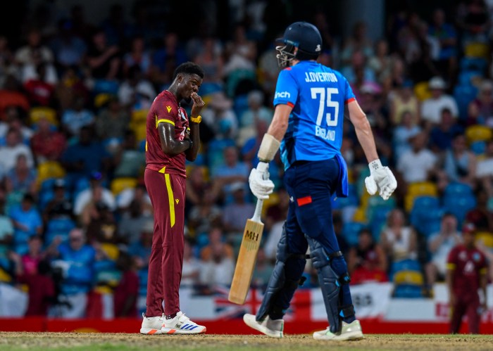 Alzarri Joseph (L) of West Indies express disappointment after Jamie Overton (R) of England hits 4 during the 3rd and final ODI match between West Indies and England at Kensington Oval, Bridgetown, Barbados, on Nov. 6, 2024.