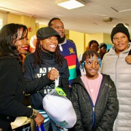 Six hundred turkeys were distributed on Nov. 23, thanks to Assembly Member Monique Chandler Waterman, Busta Rhymes, Special Ed, LinkNYC, NYC Public Schools Chancellor Melisa Ramos and IAMWONDAWOMAN. From left are Celeste Terry, Superintendent District 18, Assemblywoman Monique Chandler, Special Ed, handing over a turkey to a resident at the Annual Harvesting Health & Harmony Thanksgiving event at PS 135, on Linden Boulevard, Brooklyn.