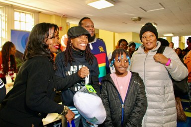 Six hundred turkeys were distributed on Nov. 23, thanks to Assembly Member Monique Chandler Waterman, Busta Rhymes, Special Ed, LinkNYC, NYC Public Schools Chancellor Melisa Ramos and IAMWONDAWOMAN. From left are Celeste Terry, Superintendent District 18, Assemblywoman Monique Chandler, Special Ed, handing over a turkey to a resident at the Annual Harvesting Health & Harmony Thanksgiving event at PS 135, on Linden Boulevard, Brooklyn.