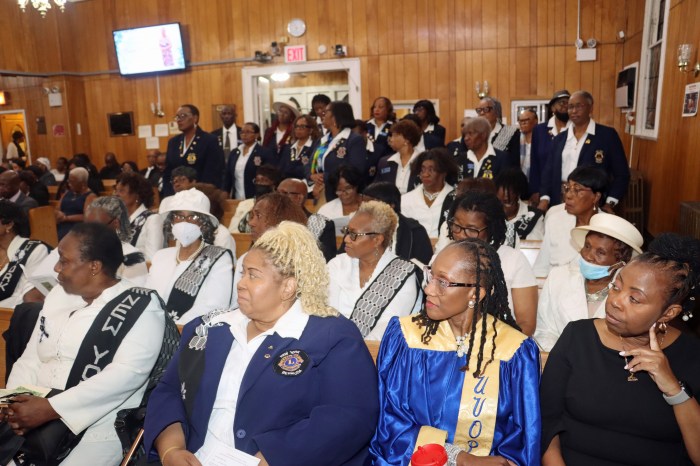 Members of the Family Life Committee, in the foreground, with Members of the Central Brooklyn Lions Club, standing, pay last respects to Cecille "Peggy" White.