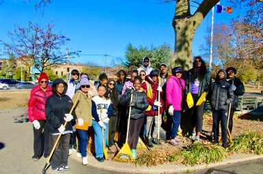 Volunteers with rakes completed their mission to clear beds and plant bulbs in Canarsie Park, Brooklyn, for a colorful spring bloom as part of the community beautification project. Founder of LEAD'N, Grenadian-national Jennifer Viechweg-Horsford, standing tall, seven from left, thanked neighborhood residents for their fantastic day of service last Saturday.