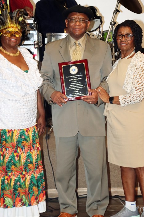 Dr. Nelson A. King displays the award, flanked by his wife, Desma, right, and Jean Joseph, president of the Brooklyn Canarsie Lions Club.