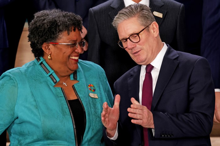 Barbadian Prime Minister Mia Mottley and British Prime Minister Keir Starmer interact as they prepare to pose for a family photo on day two of the UNFCCC COP29 Climate Conference at Baku Stadium on November 12, 2024 in Baku, Azerbaijan. The COP29, which is running from November 11 through 22, is bringing together stakeholders, including international heads of state and other leaders, scientists, environmentalists, indigenous peoples representatives, activists and others to discuss and agree on the implementation of global measures towards mitigating the effects of climate change. According to the United Nations, countries made no progress over the last year in reducing global emissions from the burning of fossil fuels.