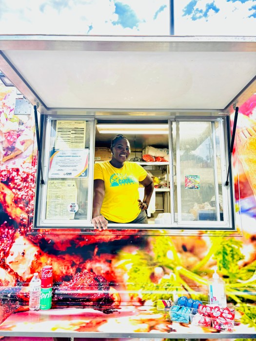 Kimbesha Campbell stands proudly at one of her outdoor events, serving from her food truck.