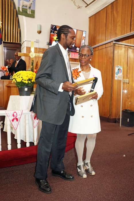 Marlene Ferguson presents a plaque to Phillip Gulbert.