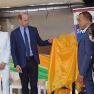 Catherine, Duchess of Cambridge, Prince William, Duke of Cambridge and Minister of Health and Wellness, Dr. the Hon. Christopher Tufton, MP unveil a plaque during a visit to Spanish Town Hospital on March 23, 2022 in Spanish Town, Jamaica.