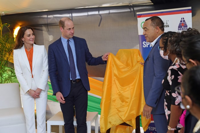 Catherine, Duchess of Cambridge, Prince William, Duke of Cambridge and Minister of Health and Wellness, Dr. the Hon. Christopher Tufton, MP unveil a plaque during a visit to Spanish Town Hospital on March 23, 2022 in Spanish Town, Jamaica.