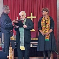 Rev Henry Fury accepts an award from Pastor Peter, CRE, for 25 years as Moderator of Session. Elder Judy Selman, Clerk of Session, is also present.