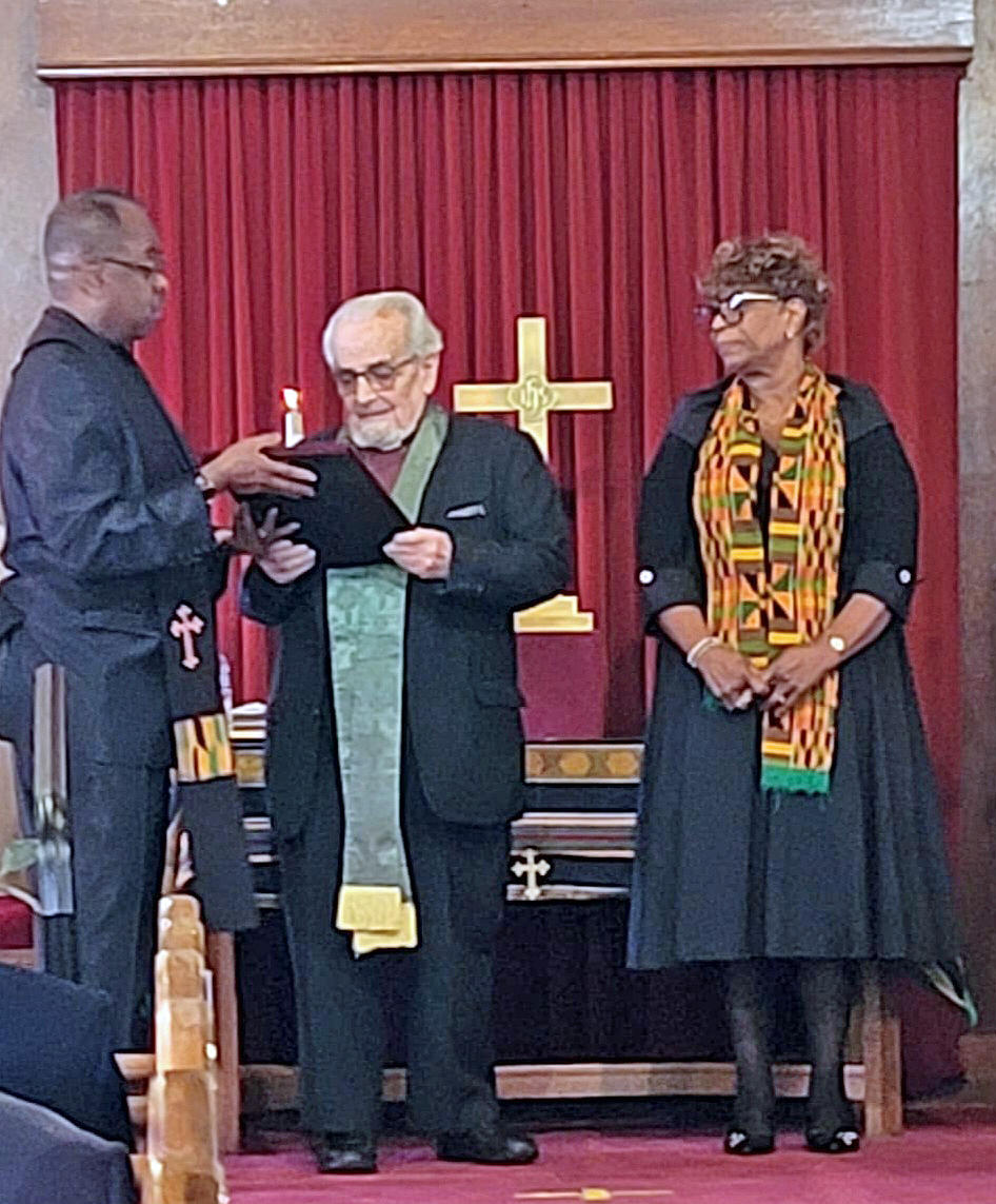 Rev Henry Fury accepts an award from Pastor Peter, CRE, for 25 years as Moderator of Session. Elder Judy Selman, Clerk of Session, is also present.