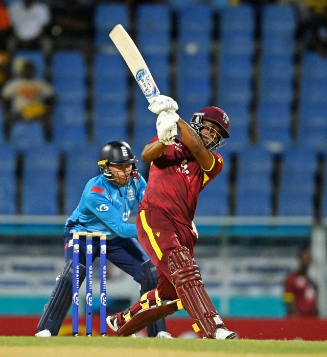 Evin Lewis of the West Indies hits out for six runs watched by England wicketkeeper Phil Salt during the first One-Day International between the West Indies and England at Sir Vivian Richards Stadium on Oct. 31, 2024 in Antigua, Antigua and Barbuda.