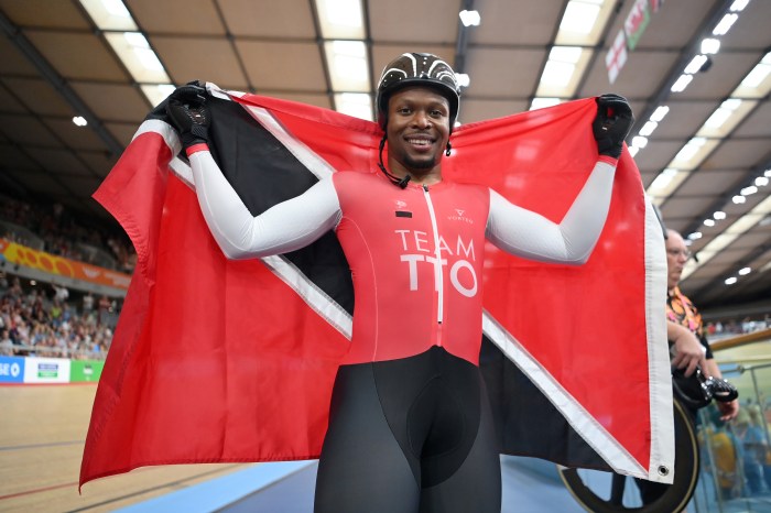 Nicholas Paul of Team Trinidad And Tobago celebrates with their flag after winning Gold during the Men's Track Cycling Keirin Final on day two of the Birmingham 2022 Commonwealth Games at Lee Valley Velopark Velodrome on July 30, 2022 on the London, England.