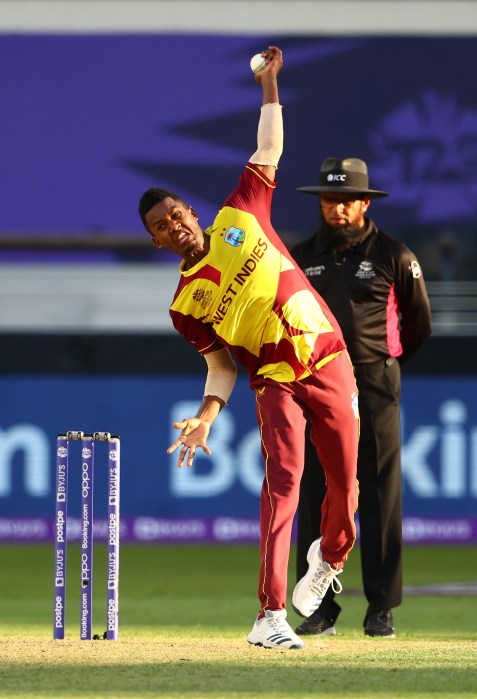 Akeal Hosein of West Indies in bowling action during the ICC Men's T20 World Cup match between South Africa and West Indies at Dubai International Stadium on Oct. 26, 2021 in Dubai, United Arab Emirates.