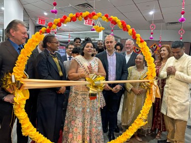 Susan Almodovar, owner of Unicare Adult Daycare, joins family, friends, and community leaders for the ribbon-cutting ceremony celebrating the opening of her new South Richmond Hill location.