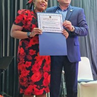 Turquoise Haskin Esq. candidate for Civil Court Judge, Kings County, Brooklyn, being presented with a Certificate of Appreciation from the organizer Saghir Khan at the WHRUSA 2024 2nd Convention and Cultural Show at Queens Palace in Woodside on Oct. 19.