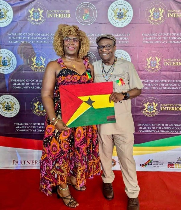 Founder and CEO of “Events by Malissa,” a Guyanese-born businesswoman Malissa Garner, now a Ghanaian citizen left, with her father Joseph Garner, proudly showcases the West African country's flag after being sworn in among more than 200 Afro-Caribbean citizens at a ceremony on Nov. 19, in Accra, Ghana.