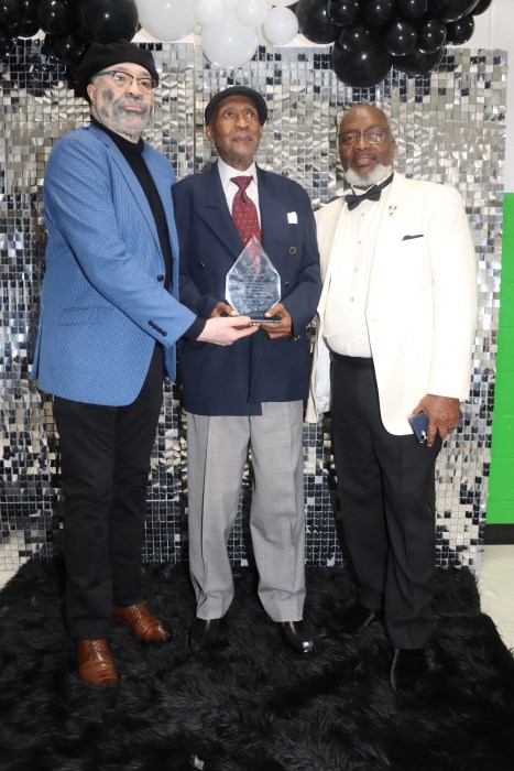 Neville Bush with award, center, with Sam Clarke, left, and Ron Simon.