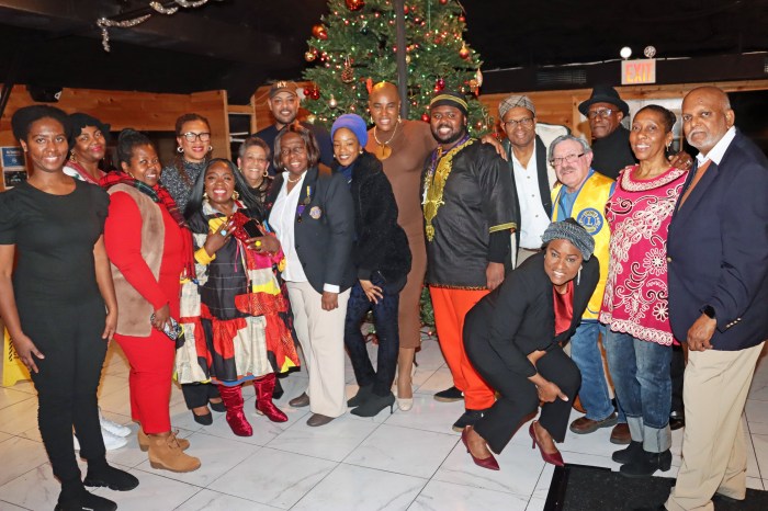 Brooklyn Canarsie Lions gather in front of the Christmas tree.