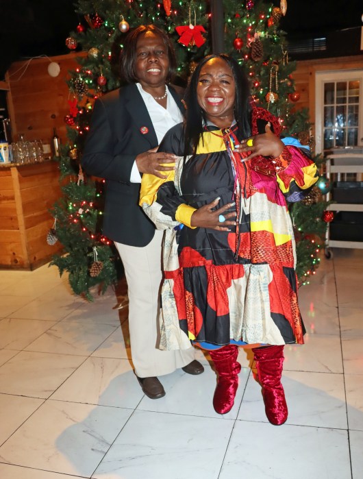 Brooklyn Canarsie Lions President Jean Joseph, left, with Aric Fuller in festive attire.