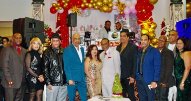 President of the Guyanese Essequibians Organization of America, Mr. Indarjeet Paul, fourth from left, poses with members of the organization at the annual Christmas party last Saturday at Liberty Palace in Richmond Hill. Kimberley Persaud, second from left, served as emcee.