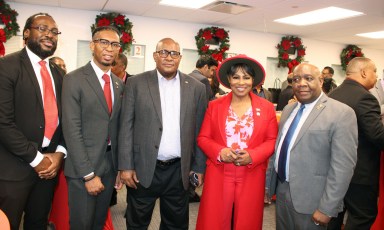 Communications Officer of the Jamaica Consulate, Christopher Benjamin, left, a guest, CG Michael E. Brotherson, CG Alison Wilson, and Sheldon Peter Anthony, Consul General of Dominica, during a festive social at the Manhattan Consulate on Dec. 18.