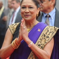 Then Prime Minister of the Republic of Trinidad and Tobago, Kamala Persad-Bissessar gestures towards media representatives during a welcome ceremonial at The Presidential Palace in New Delhi on Jan. 6, 2012.